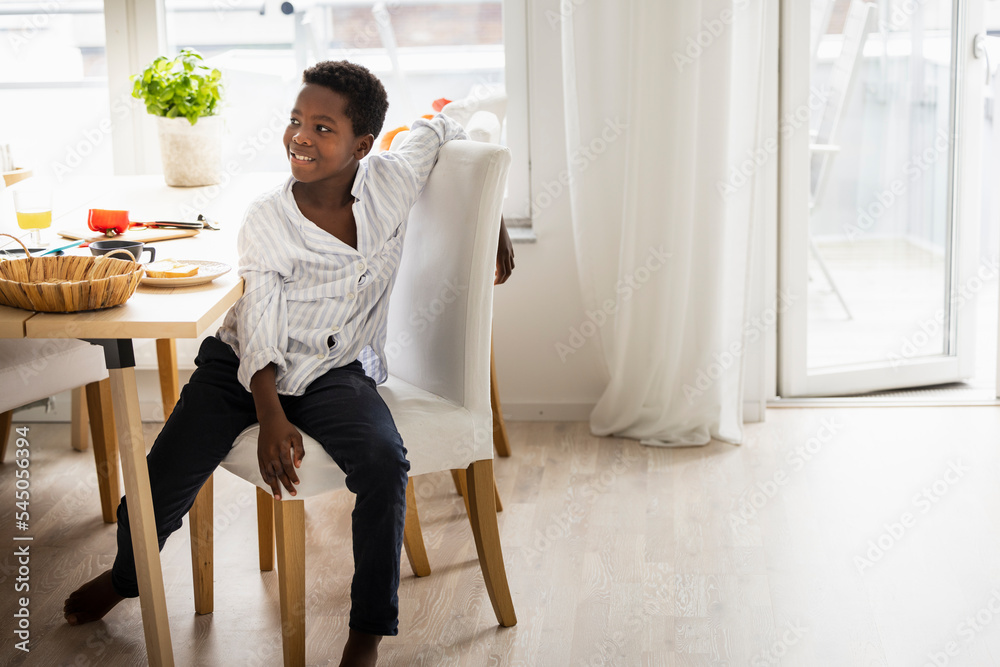 Boy sitting at table at home Boy sitting at table at home