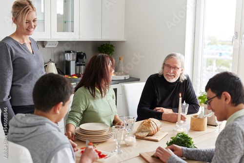 Family sitting at table at home photo