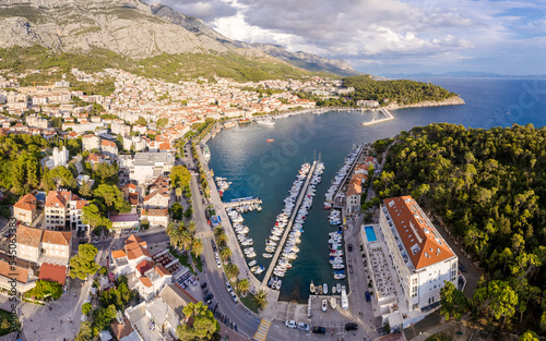 Aerial view of amazing boats in Croatia. Minimalistic landscape background with boats and sea in marina bay. Top view from drone of harbor with yacht, motorboat and sailboat. Beautiful port