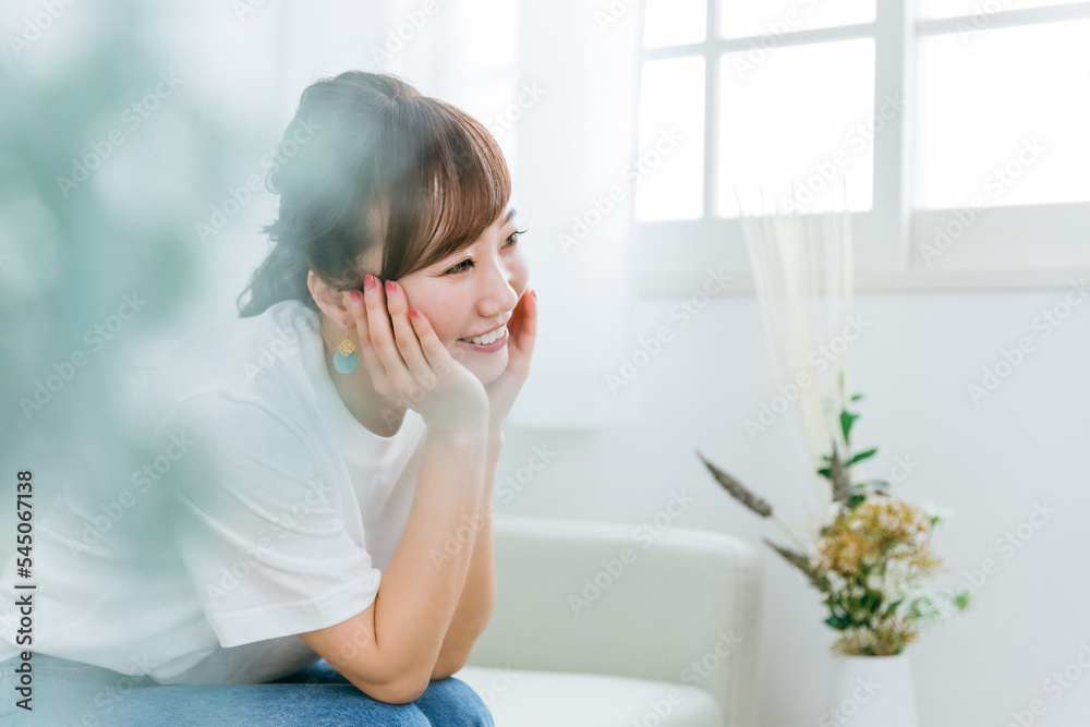 家のソファで会話して楽しそうな日本人女性
