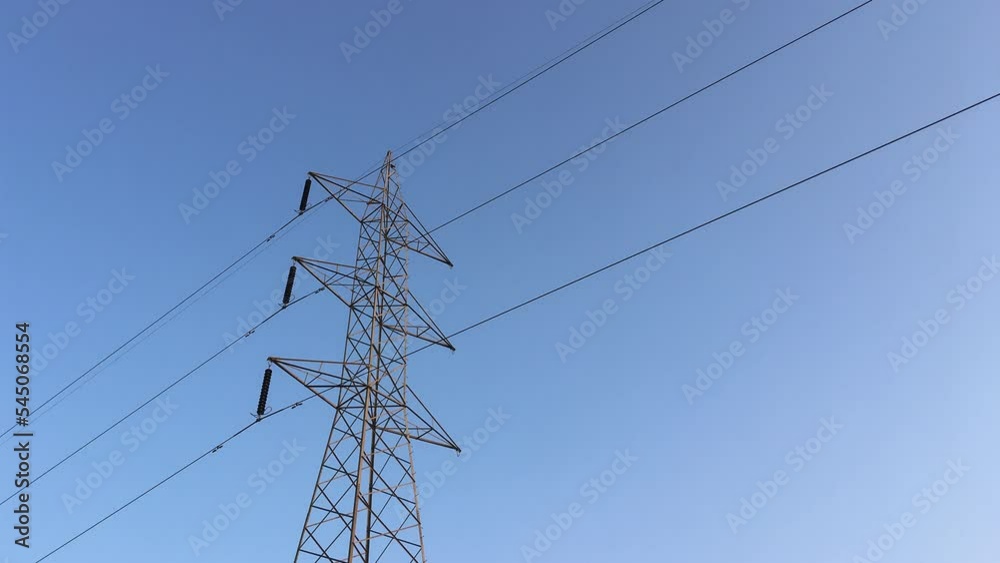 Electricity transmission towers with glowing wires Electricity transmission towers with glowing wires