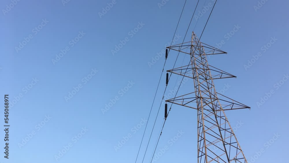 Electricity transmission towers with glowing wires Electricity transmission towers with glowing wires