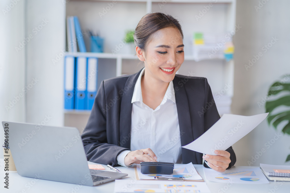 Portrait of beautiful smiling young entrepreneur businesswoman holding cup of coffee and working on laptop computer at office. Panoramic background. Portrait of beautiful smiling young entrepreneur businesswoman holding cup of coffee and working on laptop computer at office. Panoramic background.