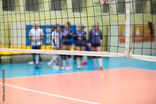 Volleyball net with a player in the background