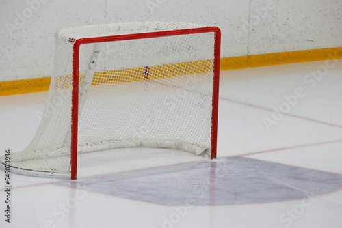 Empty ice hockey goal in ice hall