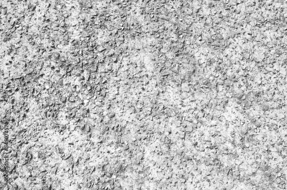 White washed out earthen floor texture background. Pebble-filled road surface. White washed out earthen floor texture background. Pebble-filled road surface.