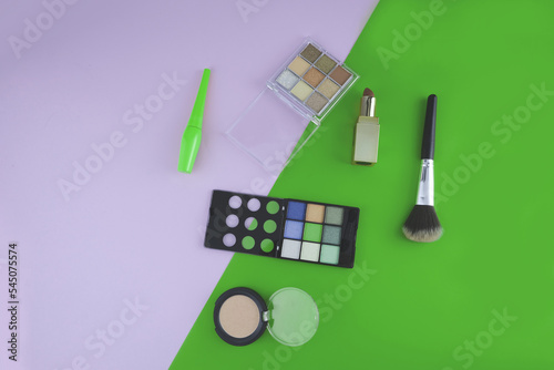 Cosmetics lipstick makeup brush eyeshadow eyebrow pencil blush eyeliner on colorful background