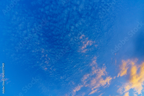 Background from glowing clouds in a dark blue evening sky