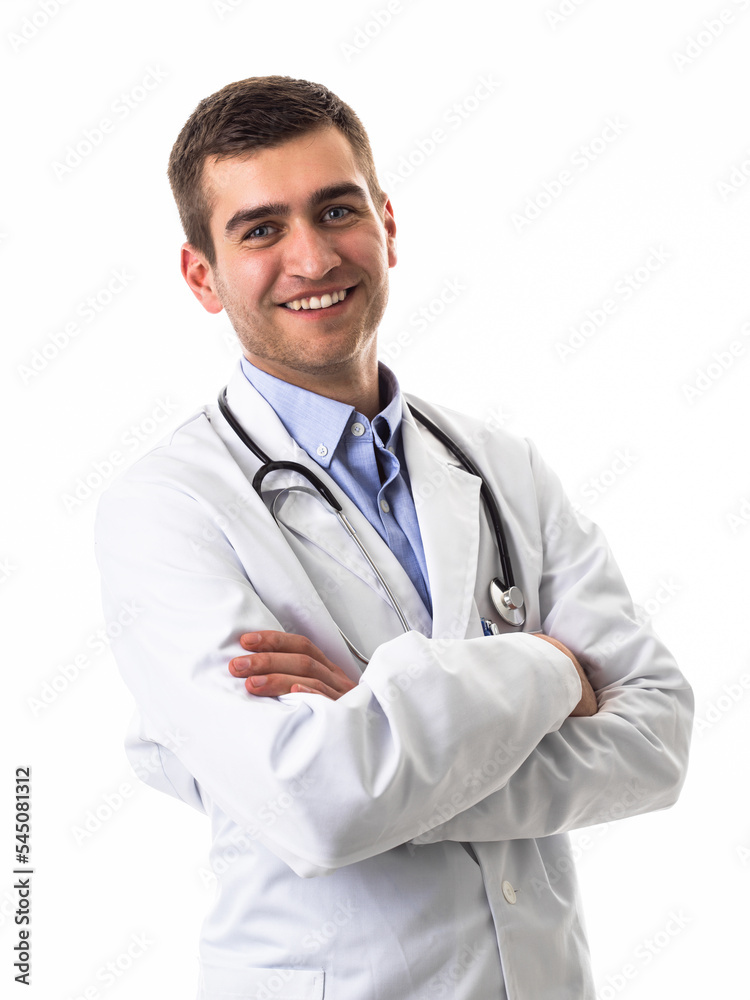 Confident male doctor in white lab coat and stethoscope standing with folded arms smiling at the camera isolated on white Confident male doctor in white lab coat and stethoscope standing with folded arms smiling at the camera isolated on white