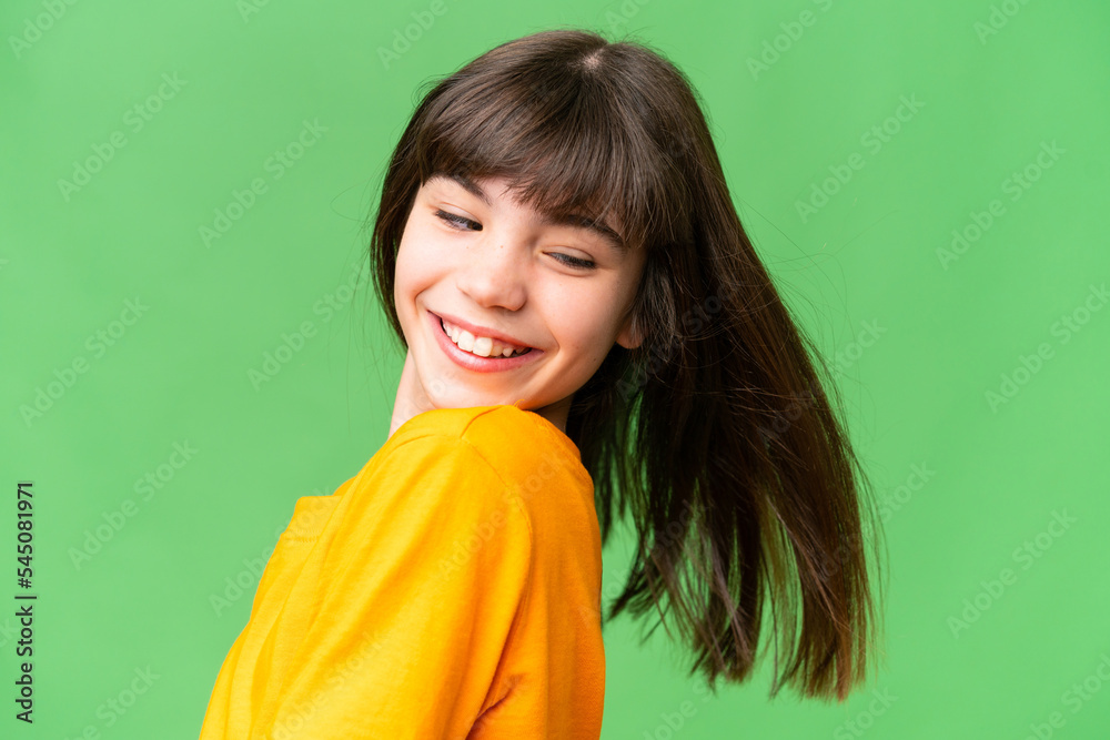 Young little brunette girl happy over isolated green background Young little brunette girl happy over isolated green background