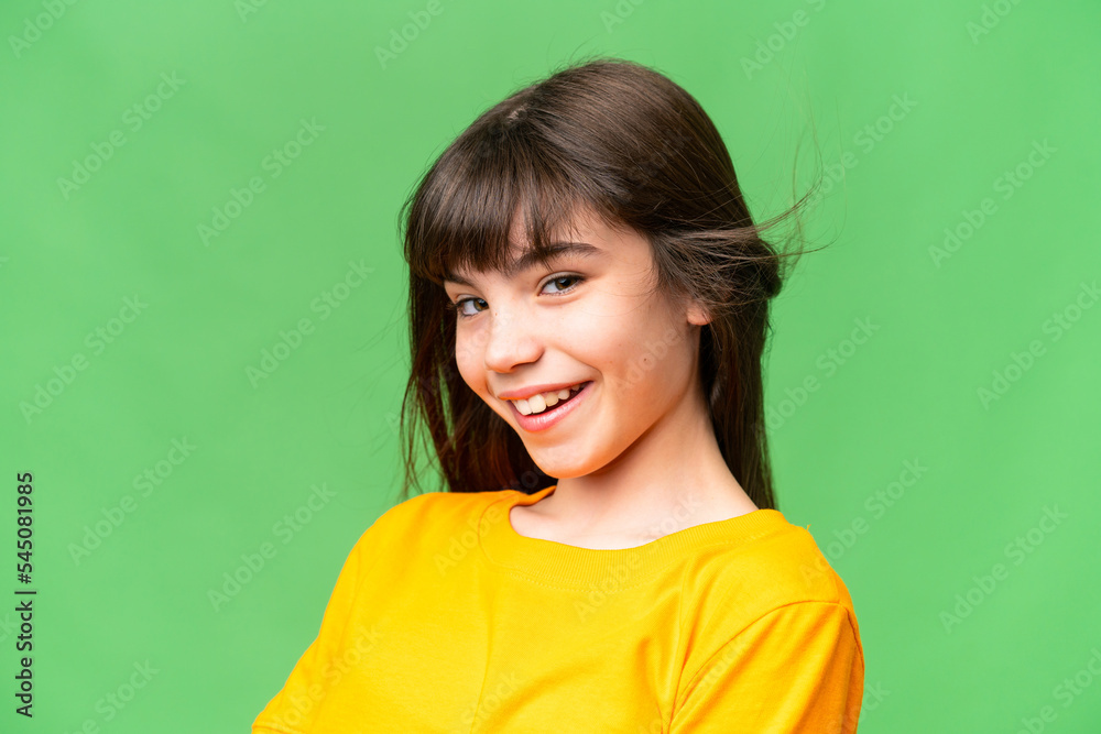 Young little brunette girl happy over isolated green background Young little brunette girl happy over isolated green background