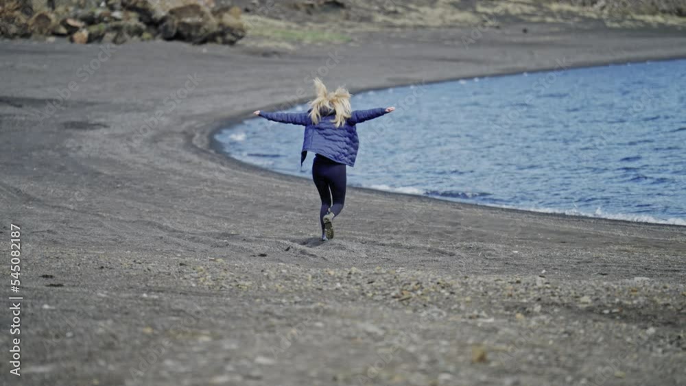 Woman In Blue Running On Beach To Sea Woman In Blue Running On Beach To Sea