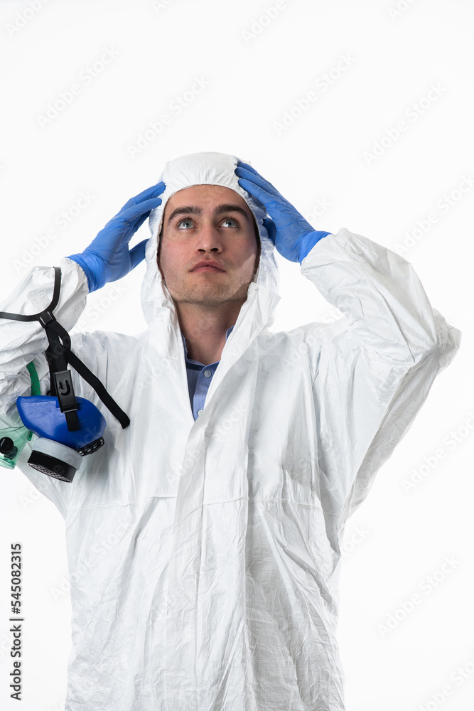 Doctor wearing protective biological suit and mask due to coronavirus 2019-nCoV global pandemic warning and danger background against white background. Doctor wearing protective biological suit and mask due to coronavirus 2019-nCoV global pandemic warning and danger background against white background.