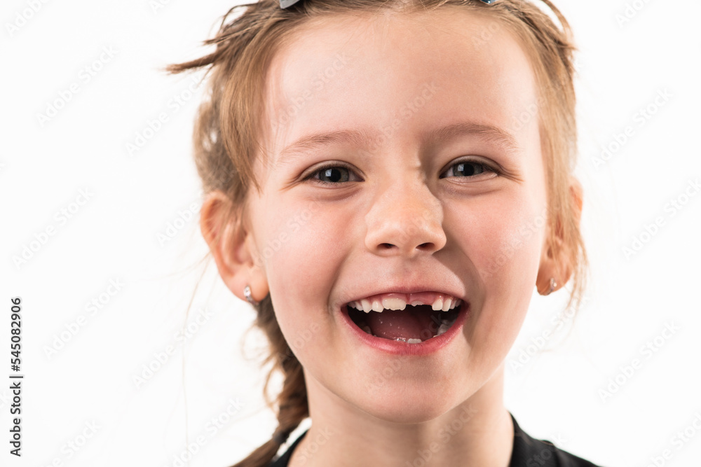 Portrait of a little girl on a white background with healthy, developing teeth Portrait of a little girl on a white background with healthy, developing teeth