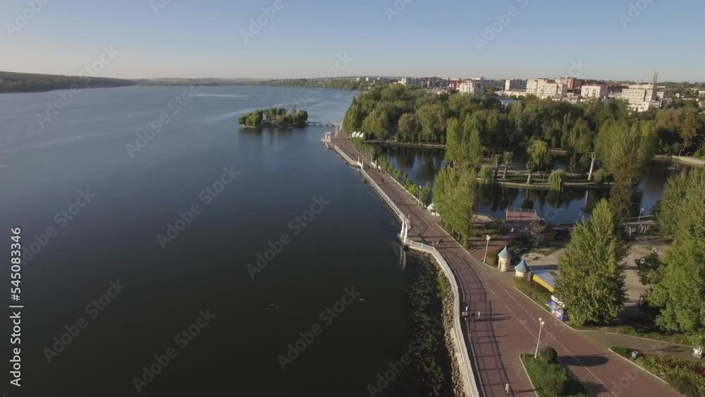 Aerial view a city on the shore of a lake with parks, attractions, bike lanes Aerial view a city on the shore of a lake with parks, attractions, bike lanes