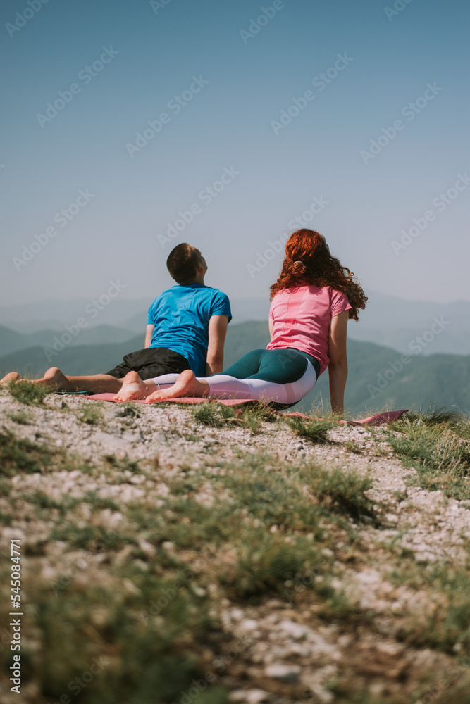 Yoga couple on the mountain streching Yoga couple on the mountain streching