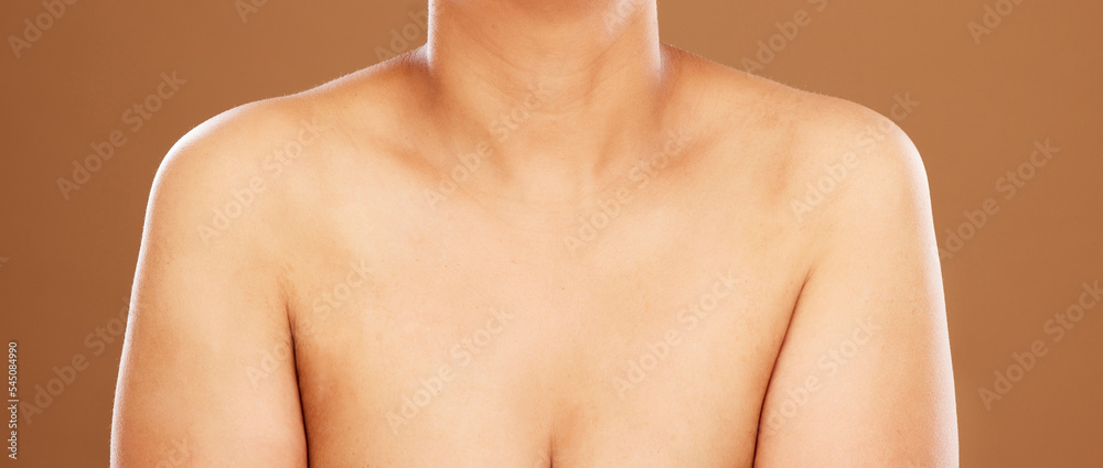Woman, chest and skincare on a brown studio background for health, wellness and breast cancer awareness. Human body, skin and bust of a female model posing naked for healthcare and self care Woman, chest and skincare on a brown studio background for health, wellness and breast cancer awareness. Human body, skin and bust of a female model posing naked for healthcare and self care