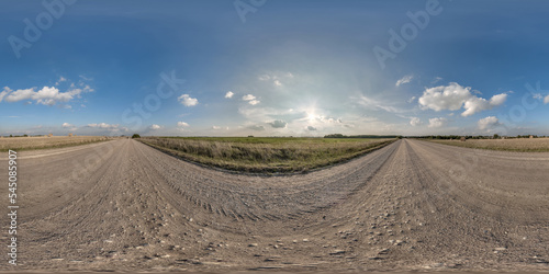 full seamless spherical hdri 360 panorama view on no traffic gravel road among fields with evening sky and white clouds in equirectangular projection can be used as replacement for sky in panoramas
