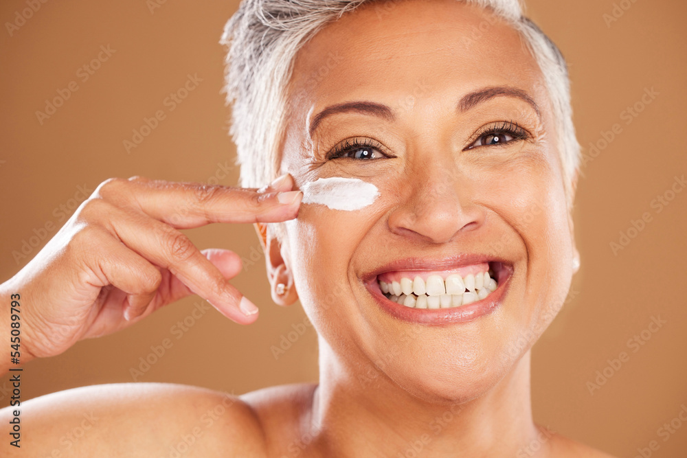 Cream, smile and senior woman with skincare for wellness, beauty and body safety against a brown studio background. Sunscreen, portrait and happy elderly model with a product for health of face Cream, smile and senior woman with skincare for wellness, beauty and body safety against a brown studio background. Sunscreen, portrait and happy elderly model with a product for health of face