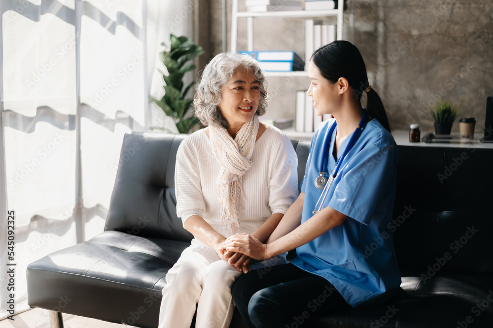Obraz premium Close up view of old woman leaning on nurse while siting.