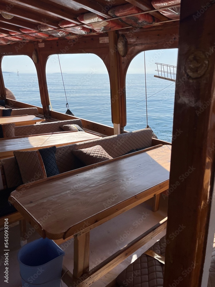 boat interior, wooden restaurant with sea view boat interior, wooden restaurant with sea view