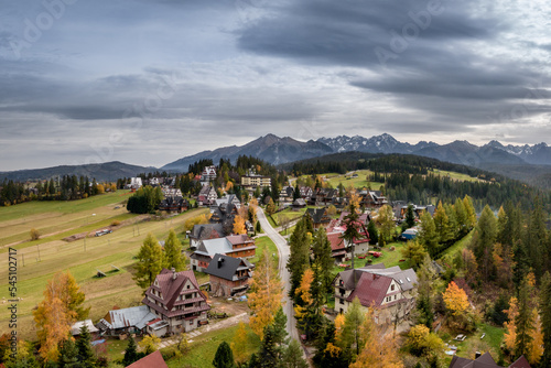 Bukowina Tatrzańska aerial autumn shot with Tatra Mountains in the background.