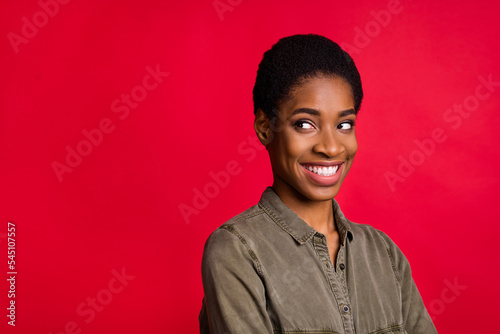 Portrait of positive androgyne lady look empty space ads wear smart casual shirt isolated bright color background photo