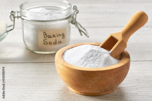 baking soda on a white wooden table, selective focus.