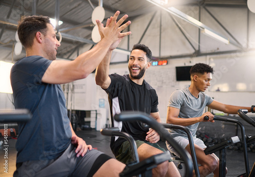 Fitness, man and high five at the gym for exercise, training or cardio workout together indoors. Happy men with smile and hands in celebration for partnership, support or sport motivation in wellness photo