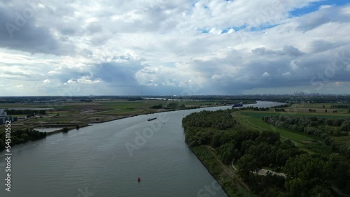 View of Schelda river in Zwijndrecht, Belgium with cargo ship sailing photo