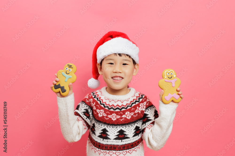 Merry Christmas! Young girl celebrating Christmas against pink background