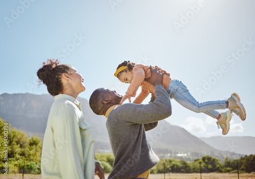 Black family, nature and parents play with child on weekend countryside vacation for peace, freedom and quality time. Love, trust and fun happy family of mother, father and kid girl bonding together