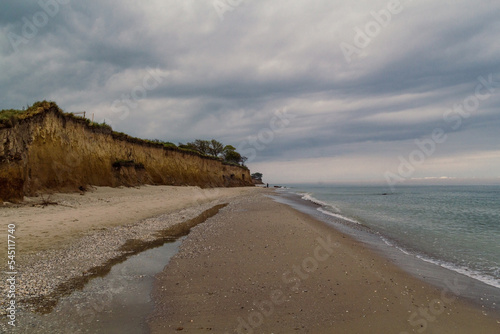 Hillside at sea beach landscape photo. Beautiful nature scenery photography with sloping side of hill on background. Idyllic scene. High quality picture for wallpaper  travel blog  magazine  article