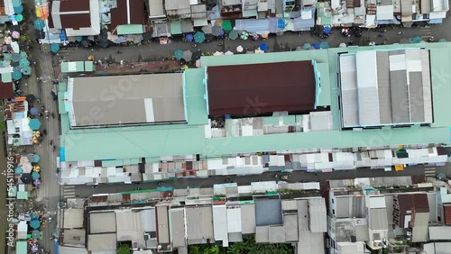 Aerial drone footage above the morning market of Tra Vinh, Vietnam, camera film down and moves from left to right. photo