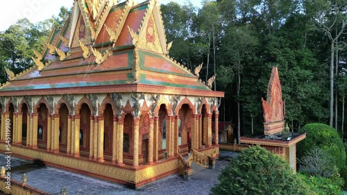 Ascending drone footage along a Khmer pagoda, Wat Koskeoserey in Tra Vinh province, south Vietnam. Beautufil architecture well preserved in great environment. photo
