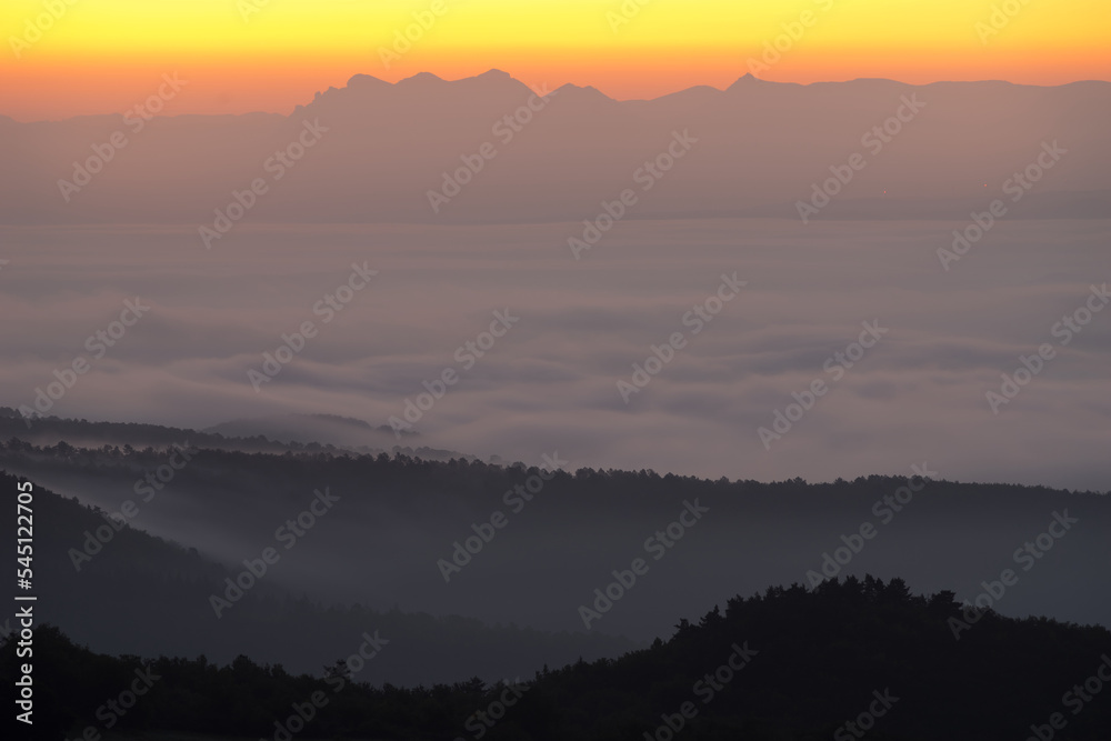 Landscape France Ardeche at Privas Creysseilles at dawn before sunrise with fog and clouds in the valleys