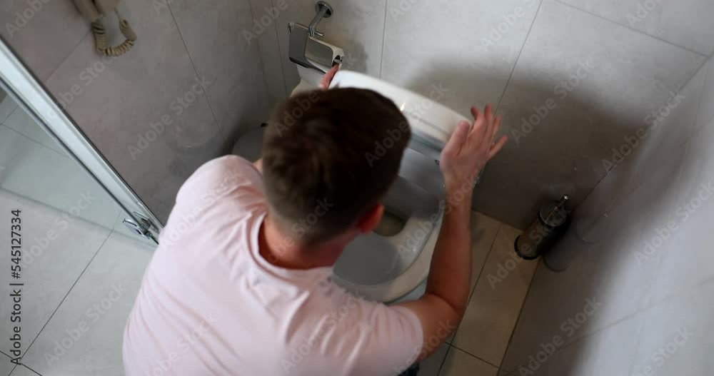 Young man vomits in toilet food poisoning Young man vomits in toilet food poisoning