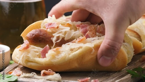 Taking Beer Bratwurst sausage with sauerkraut and bacon.