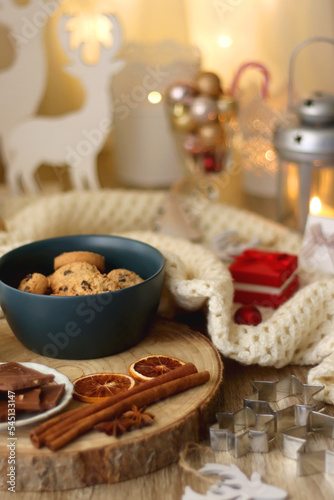 Various Christmas decorations  cup of tea or coffee  sweets  small presents  knitted blanket and candles. Selective focus.