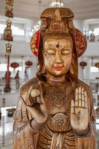The Temple of Mercy (Guanyin) in Chiang Rai, Thailand sits on top of a mountain has a series of wooden female Buddha figures upstairs in the main temple building.