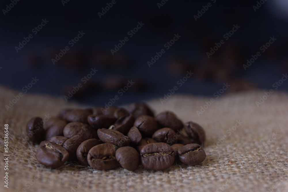 a macro view of coffee beans on jute textile, selective focus on coffee beans a macro view of coffee beans on jute textile, selective focus on coffee beans