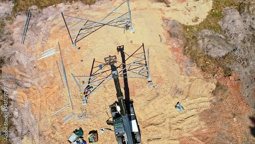 Construction of a electrical transmission tower pylon - orbiting aerial view