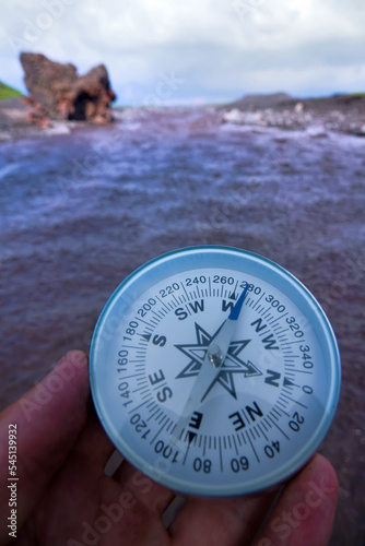 The right compass is always needed for travelers, adequate course. Hiking on the shore of Lake Baikal in Siberia photo