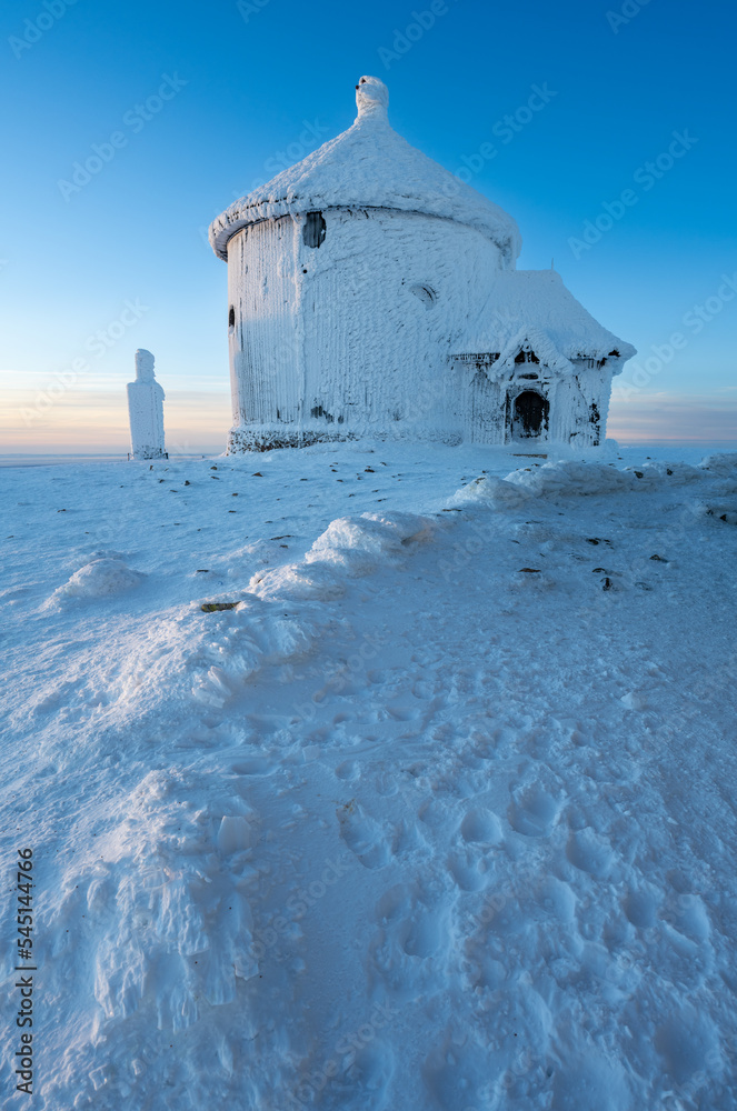 Peak of Sniezka mountains during winter sunrise in Poland and Czech republic border in Giant mountains