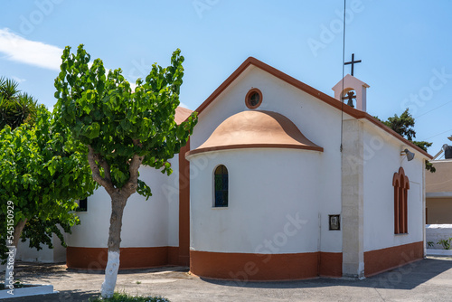 The back of a small beautiful red and white colored church (Ekklisia Sotiros Christos Monastiri) in Rethymno, Crete, Greece photo