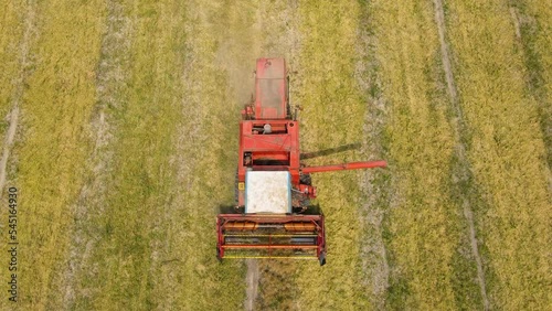 Aerial view agriculture machinery, traktor ride on day time working field tractor plow