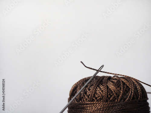 Canvas Print Brown ball of yarn and threaded needle