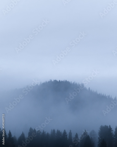 Mountain covered by fog on a misty morning