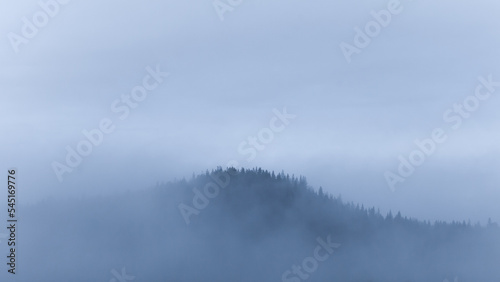 Small mountain covered in fog © Ida Wastensson