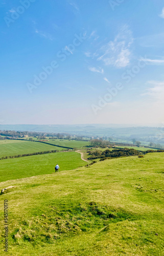 Portrait or vertical shot of man walking into the distance in North Yorkshire countryside